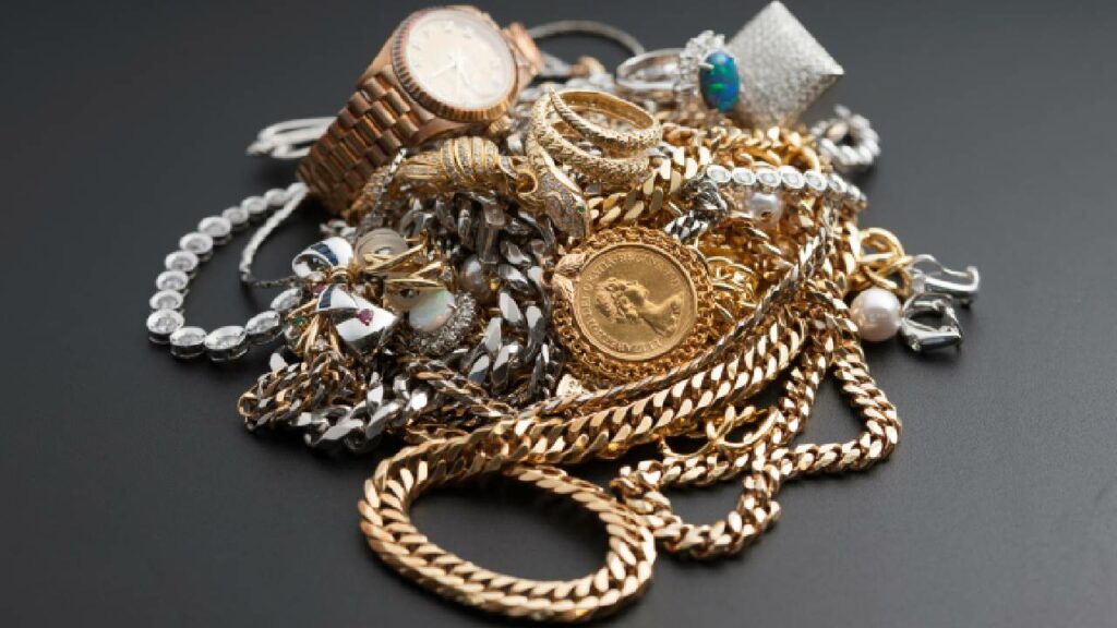 pile of precious metal jewellery on a black background