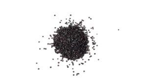 A scattered pile of small black plastic pellets on a white background, representing raw black plastics used in manufacturing and recycling.