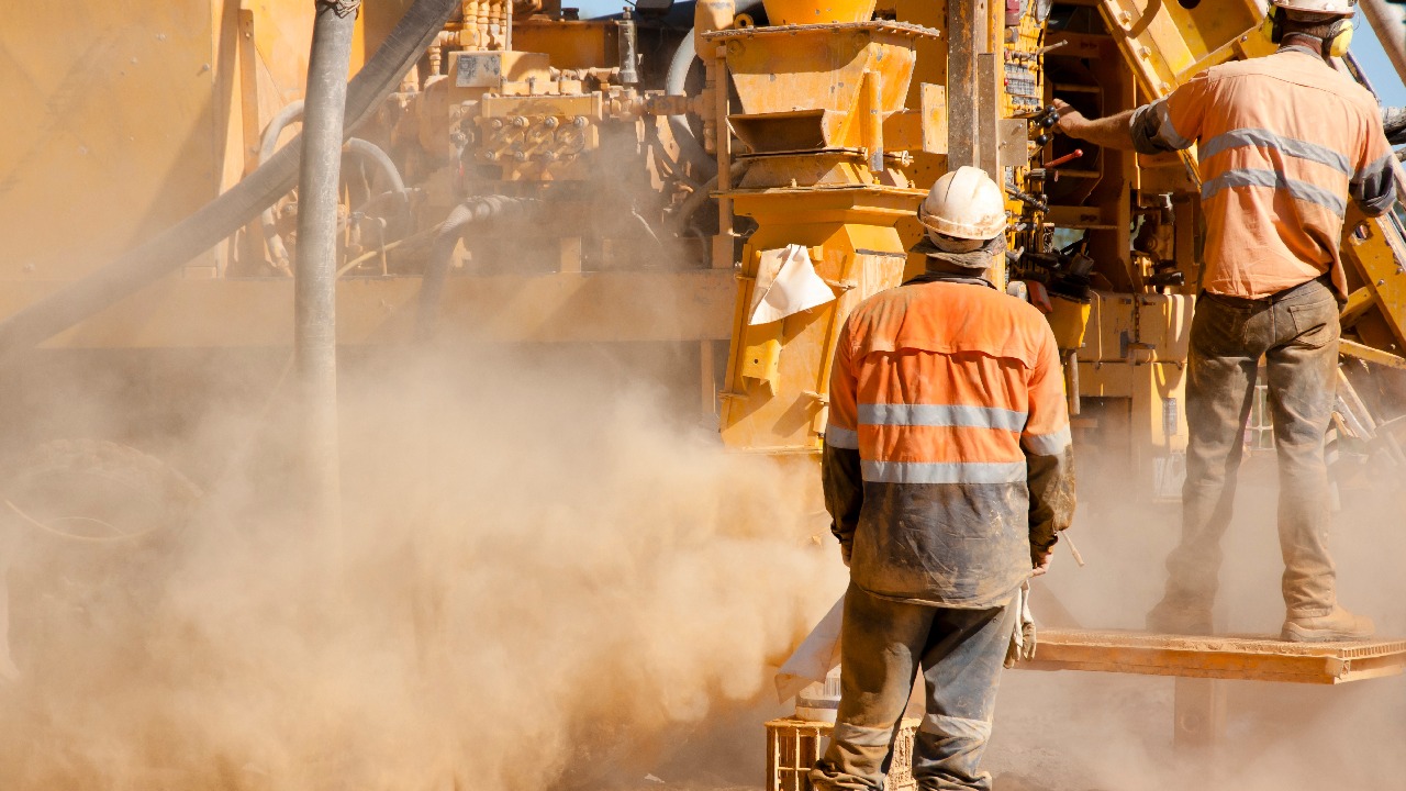 Australia Is Drilling More Than Ever — So Why Aren't We Finding More? The Case for Mineralogy at the Drill Site 1 Mining workers operate a drilling rig at an Australian exploration site, surrounded by dust as core drilling equipment extracts underground samples during mineral exploration.